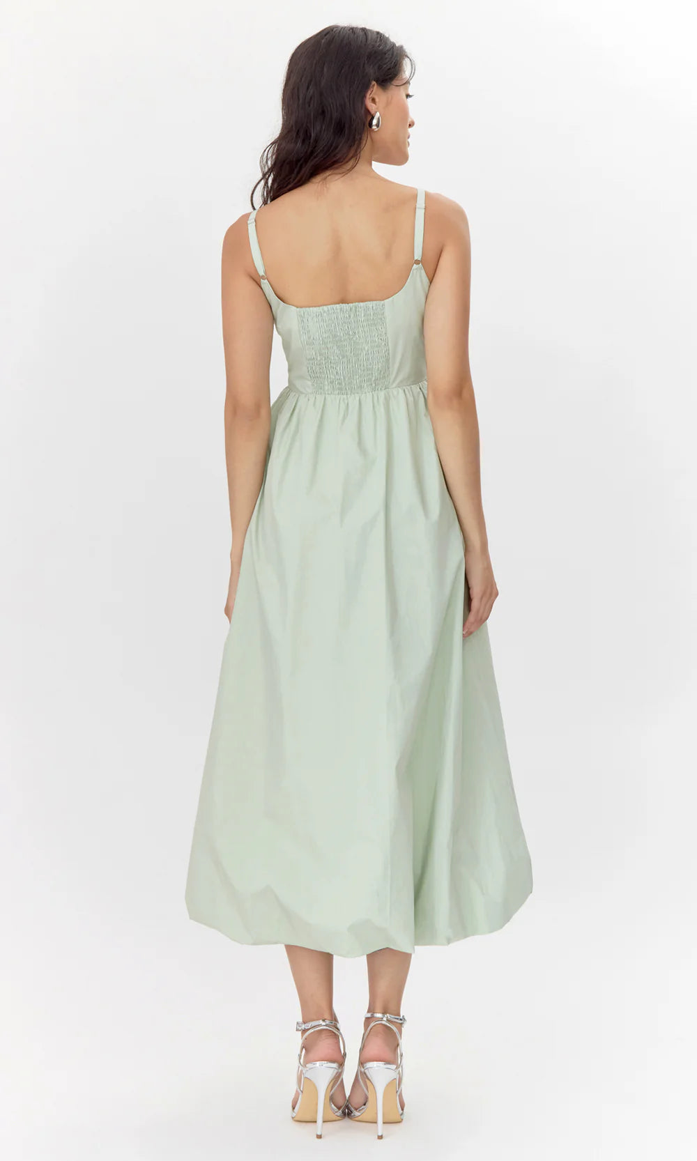 This midi dress is defined by it's bold and playful bubble skirt. The structure showcases hidden pockets, a smocked back, and a square neckline.
