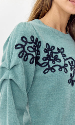 Add a touch of quirkiness to your wardrobe with Greylin's Cooper embroidered sweater. Playfully embroidered with unique designs, this sweater will have you standing out in style. Effortlessly blend fashion and fun with this must-have piece.