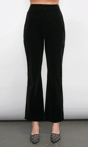 Black flared pants worn by a person on a plain background
