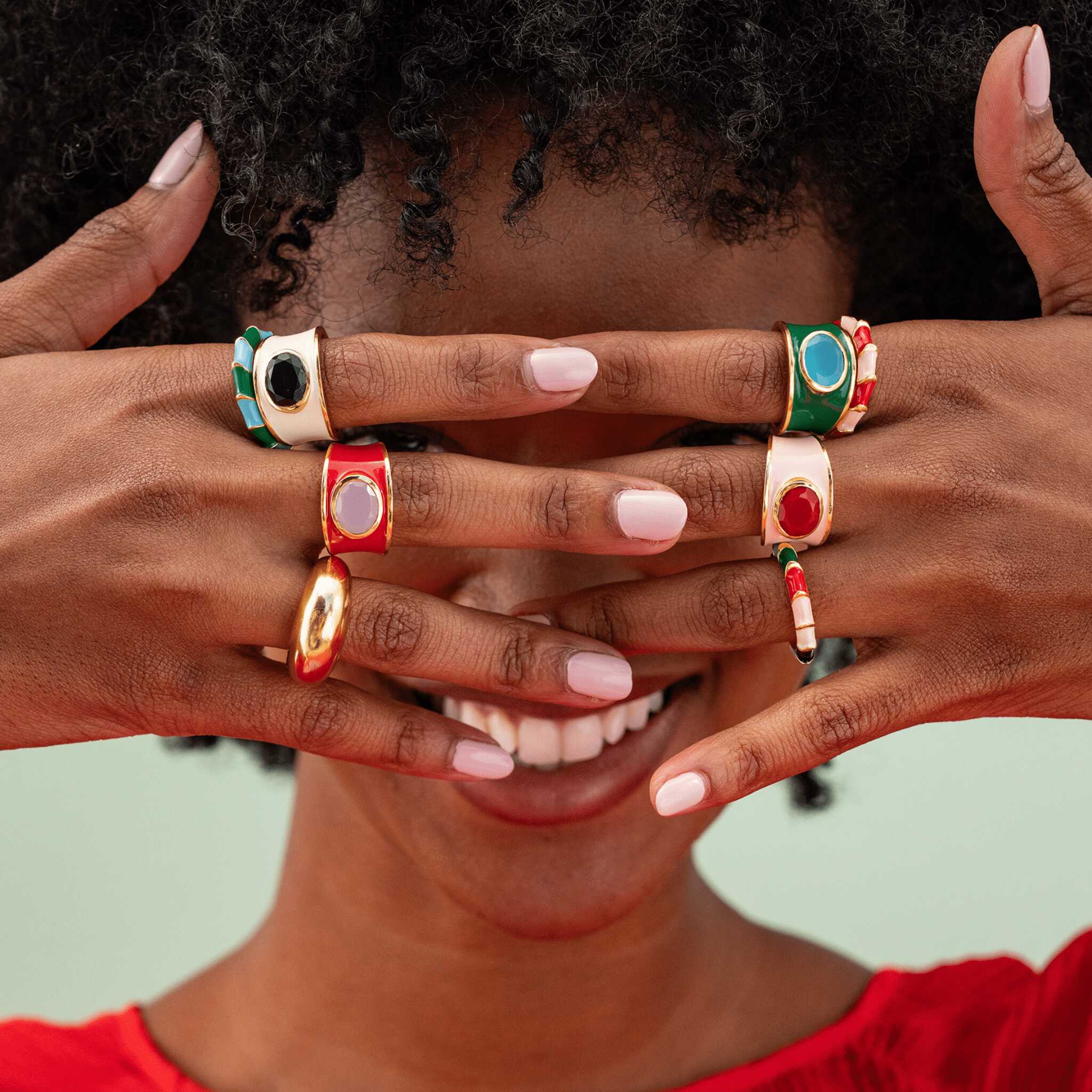 Make a bold statement with the Hazel Oval Stone with Enamel Band Ring. This cocktail ring features an oval-shaped semi-precious stone, such as Black Onyx, Red Jade, Green Onyx, Rainbow Moonstone, or other colors, surrounded by an enamel band. It adds a touch of sophistication and elegance to any outfit.