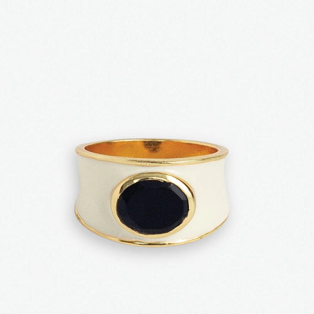 Make a bold statement with the Hazel Oval Stone with Enamel Band Ring. This cocktail ring features an oval-shaped semi-precious stone, such as Black Onyx, Red Jade, Green Onyx, Rainbow Moonstone, or other colors, surrounded by an enamel band. It adds a touch of sophistication and elegance to any outfit.