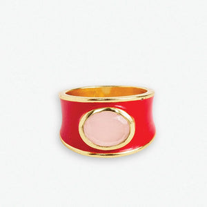 Make a bold statement with the Hazel Oval Stone with Enamel Band Ring. This cocktail ring features an oval-shaped semi-precious stone, such as Black Onyx, Red Jade, Green Onyx, Rainbow Moonstone, or other colors, surrounded by an enamel band. It adds a touch of sophistication and elegance to any outfit.