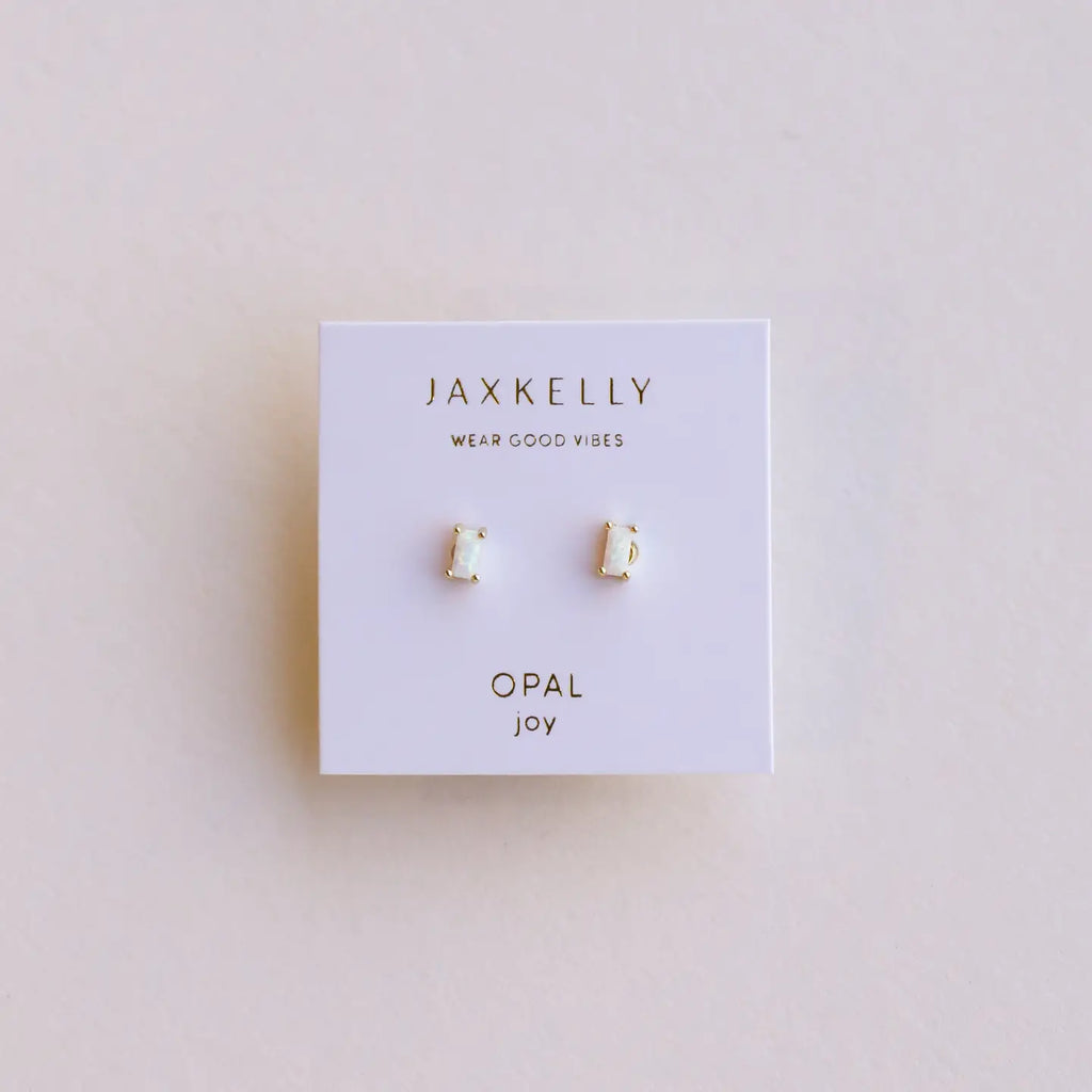 Jaxkelly opal joy earrings on a branded card with a light pink background