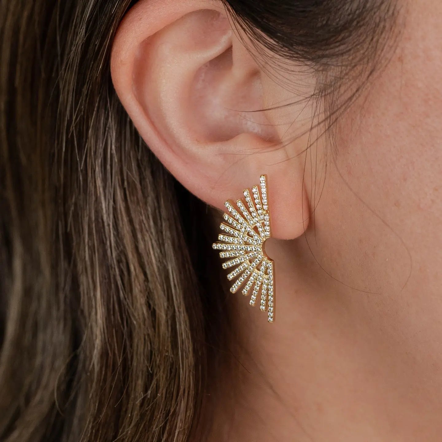 Our bold Sunburst Drop earrings feature a large sunburst pattern of pave stones. These earrings are perfect for any occasion with their timeless sophistication.