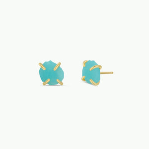 Turquoise earrings with gold accents on a white background