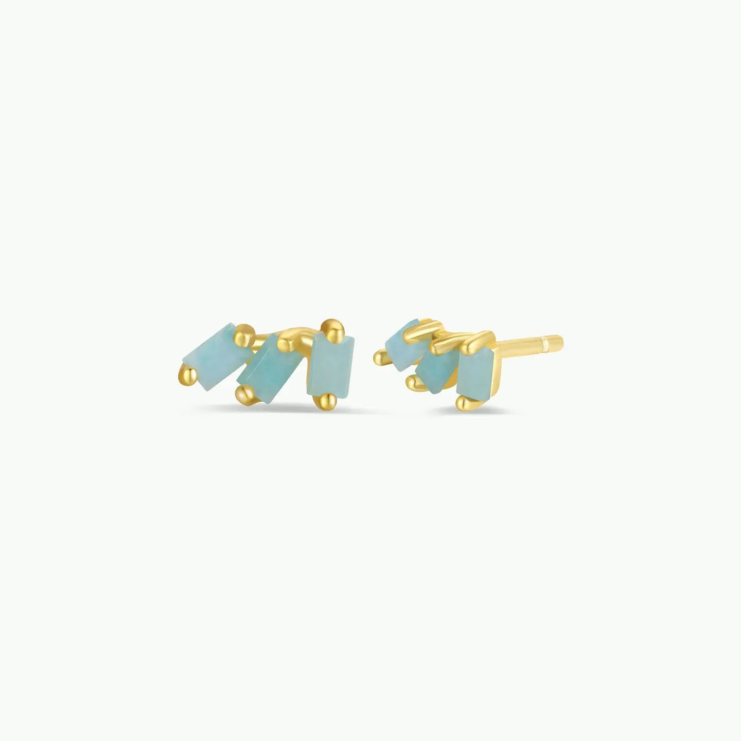 Pair of gold and light blue earrings on a white background