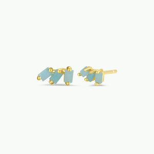 Pair of gold and light blue earrings on a white background