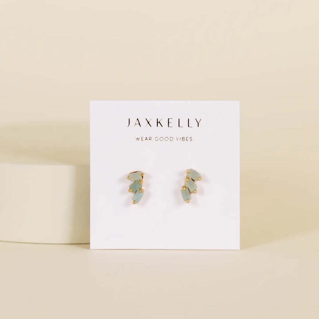 Pair of earrings on a Jaxkelly branded card with a beige background