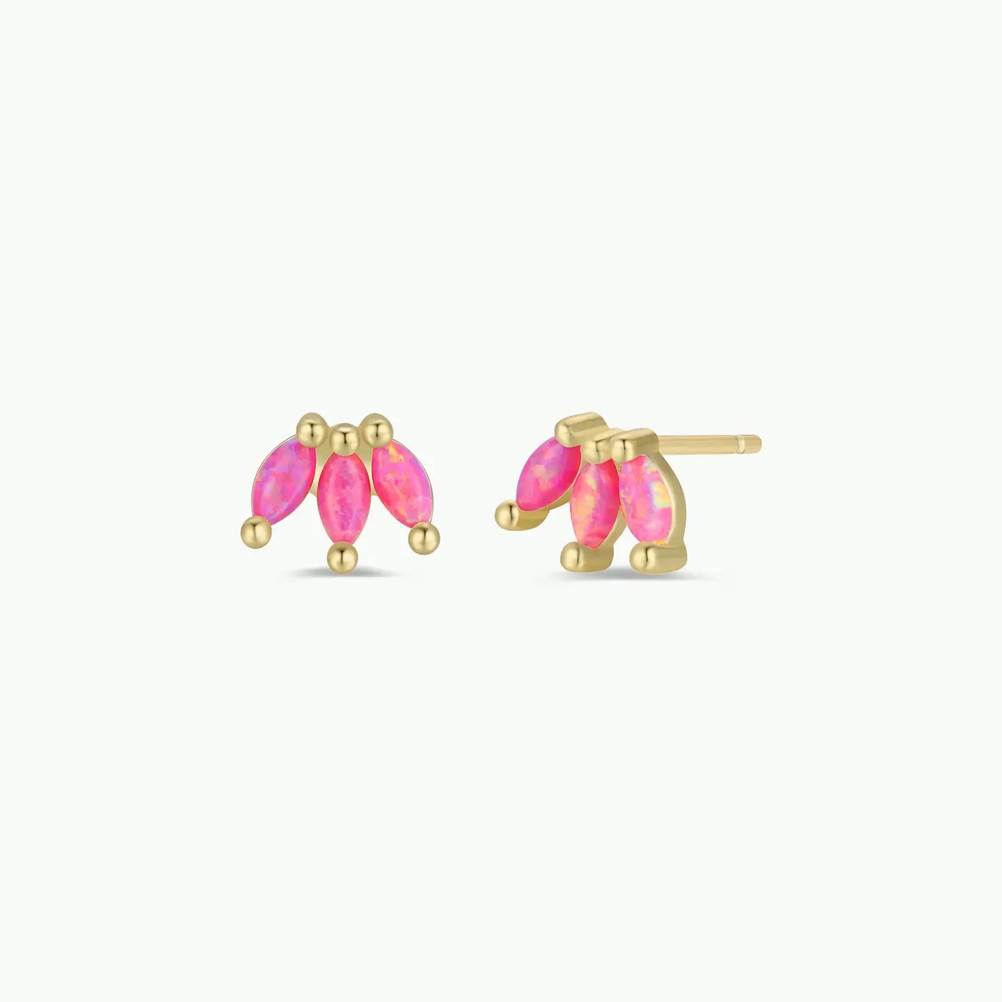 Gold earrings with pink gemstones on a white background