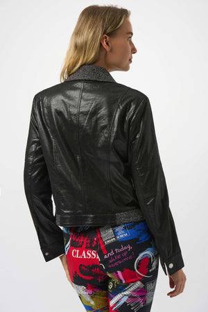 Person wearing a black leather jacket with a colorful skirt on a white background