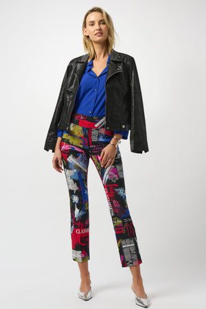 Woman wearing a black jacket, blue shirt, and colorful pants on a white background