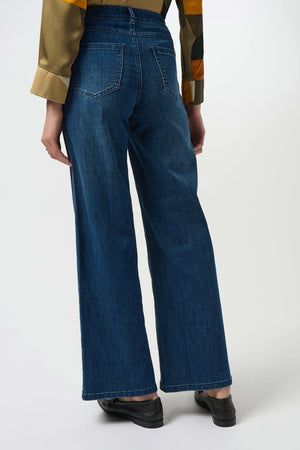 Person wearing blue jeans on a white background