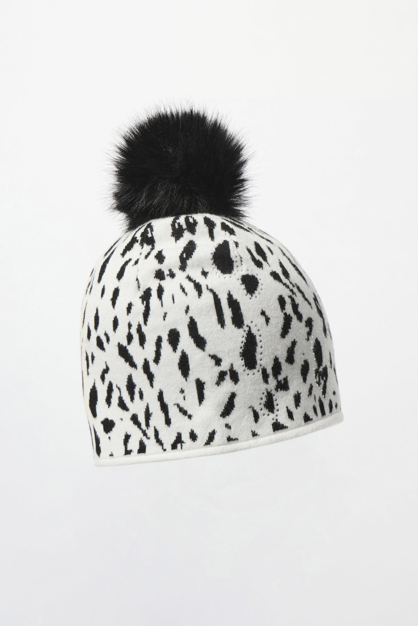 White beanie with black animal print and a black pom-pom on a white background