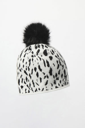 White beanie with black animal print and a black pom-pom on a white background