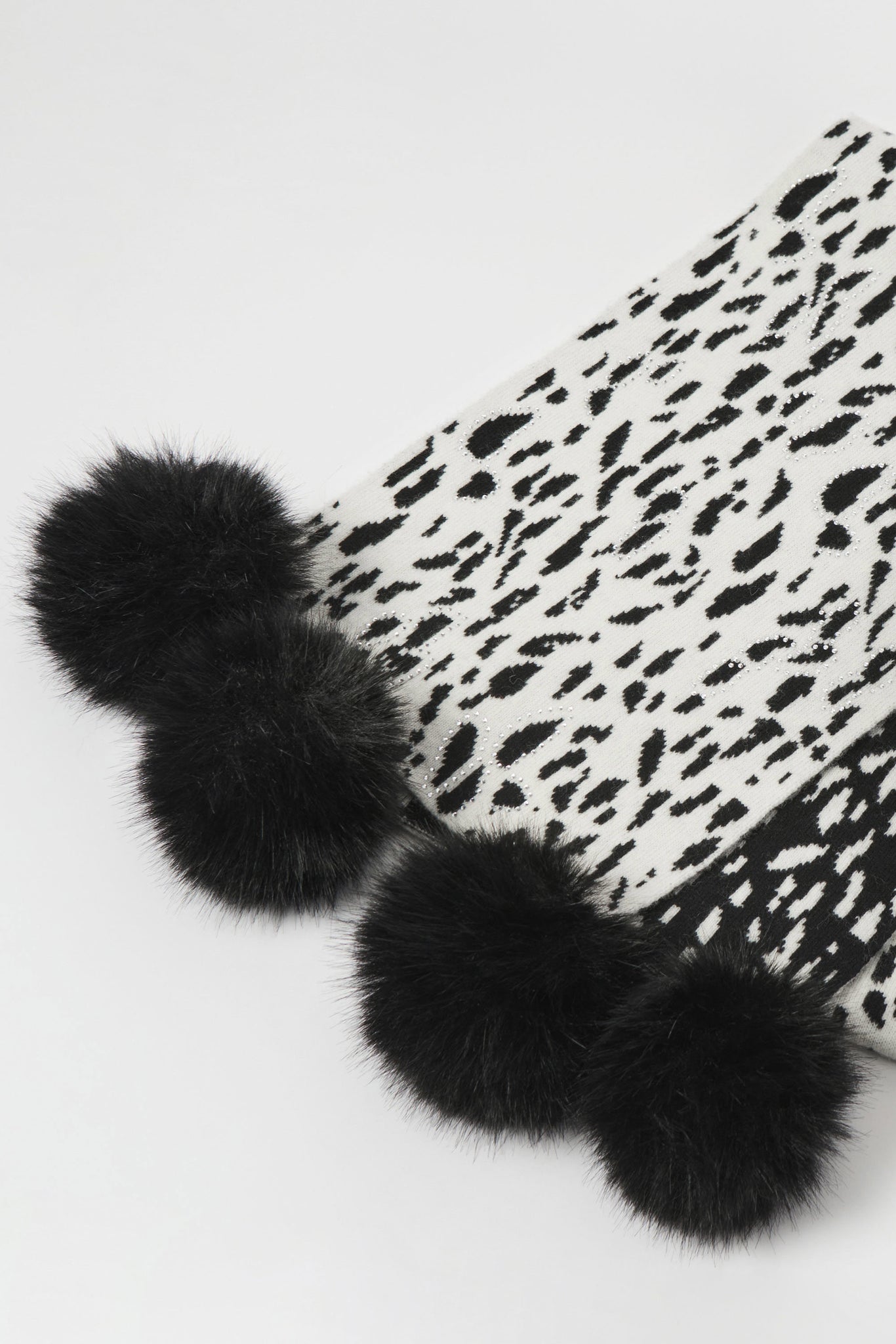 Black fur pom-poms on a white background