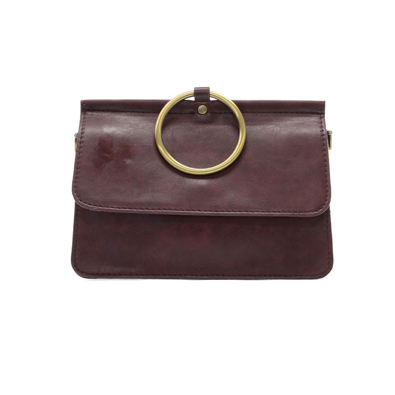 Brown leather handbag with gold ring handle on a white background