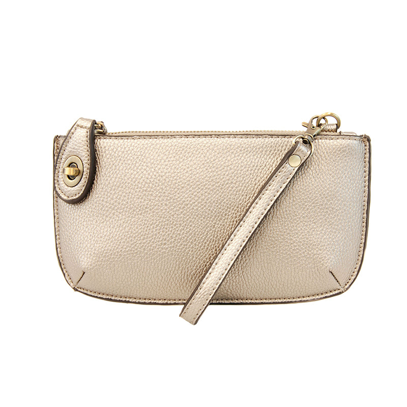 Gold metallic clutch bag with a strap on a white background