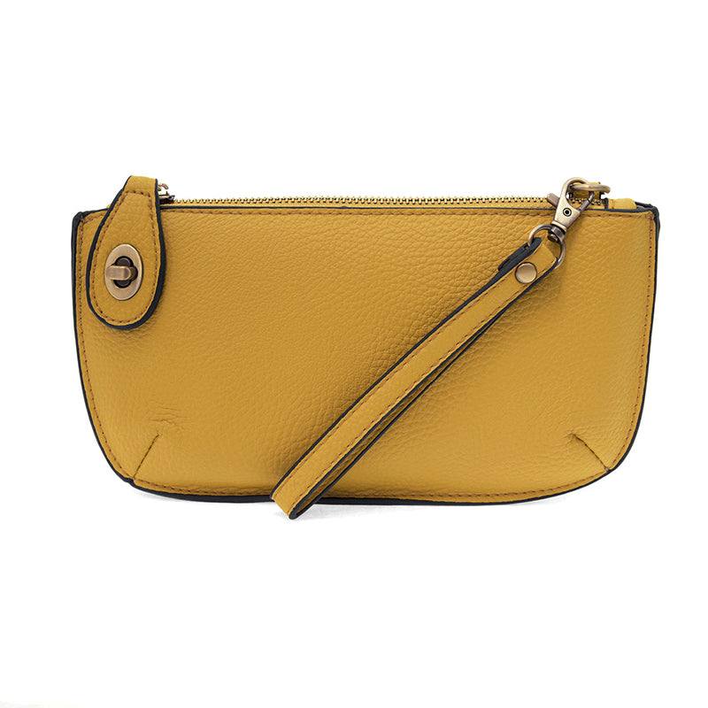 Yellow leather handbag with a strap on a white background