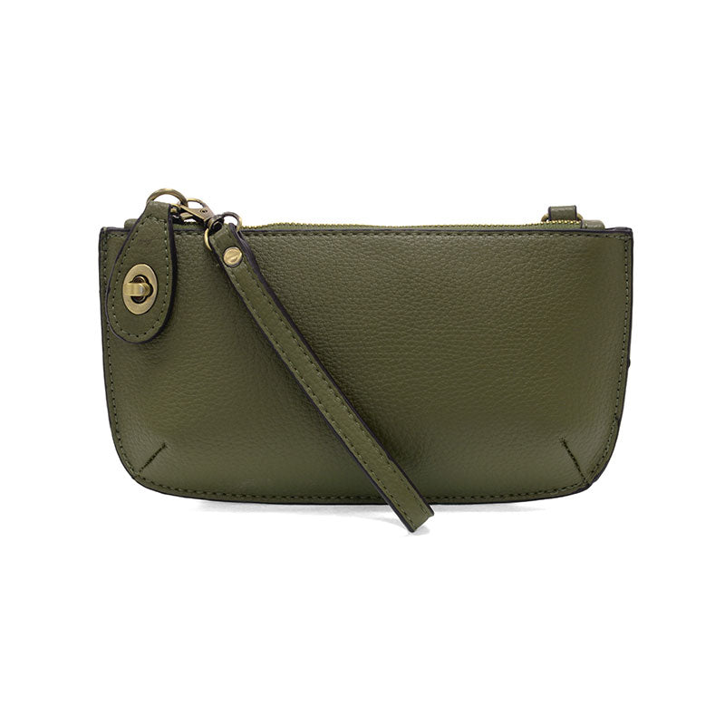 Green leather clutch with a strap on a white background
