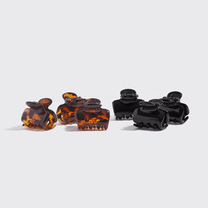 Set of tortoiseshell and black hair clips on a white background