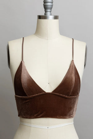 Brown velvet top on a mannequin against a gray background