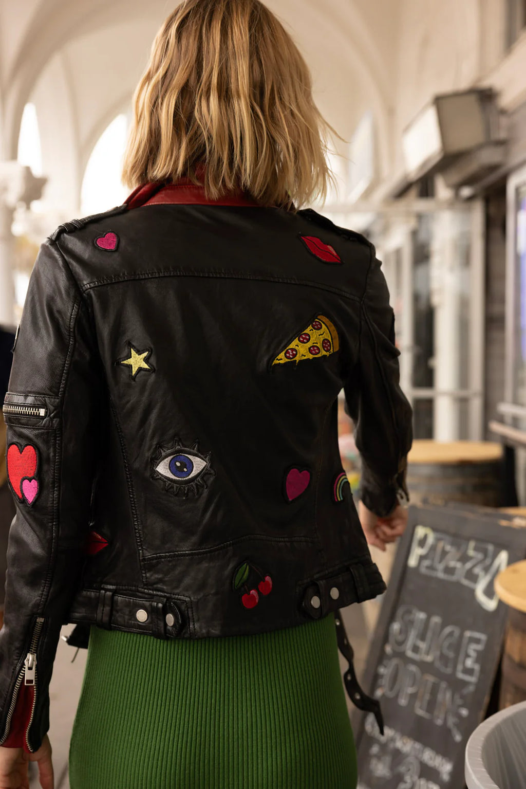 Step out in style with Tavi, a unique twist on the classic moto jacket. Crafted from genuine leather, the piece has a whimsical design with embroidered patches that will give you an edgy look!