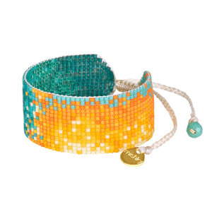 Get ready to add a pop of color to your wrist with Mishky's Vivid sunset-inspired beaded bracelet! Each bracelet is handcrafted with vibrant hues, bringing a touch of color to any outfit.