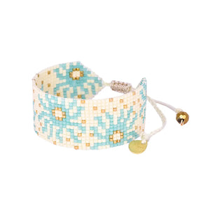 Shine bright with Mishky's beaded sun adjustable bracelet! Effortlessly add a touch of unique style to any outfit with this playful accessory. Adjust the fit to your liking and let the sun's positive energy radiate through your day.