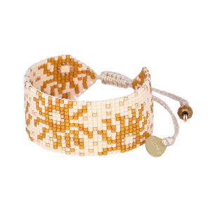 Shine bright with Mishky's beaded sun adjustable bracelet! Effortlessly add a touch of unique style to any outfit with this playful accessory. Adjust the fit to your liking and let the sun's positive energy radiate through your day.