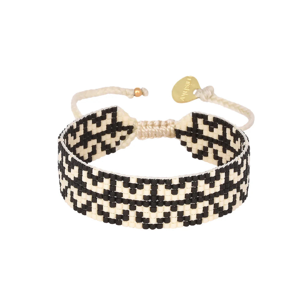 Add some candele (candle) to your wrist game with Mishky's adjustable beaded bracelet in black and white. Turn heads with this unique and versatile accessory. Light up your style with Mishky | Candele!