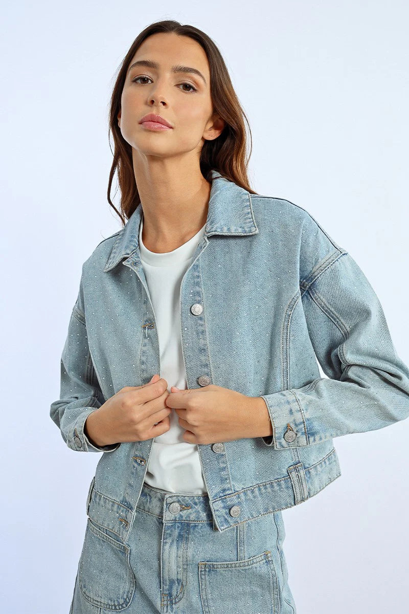 Sparkle in style with this playful denim jacket adorned with eye-catching rhinestones!