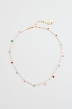 Elevate your elegance with the Nakamol Kindness necklace, featuring a delicate strand of lustrous white pearls accented by vibrant multi-color stone dangles. This refined piece adds a subtle yet striking splash of color, perfect for enhancing both formal and everyday ensembles with timeless sophistication.