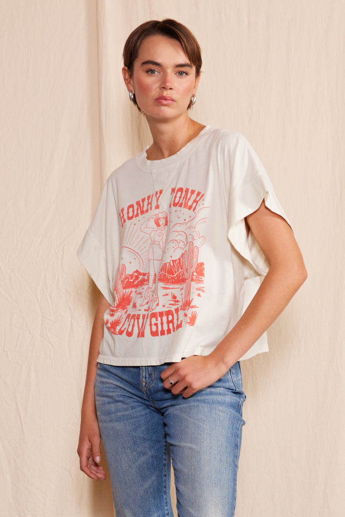 Saddle up with the People of Leisure Honky Cowgirl tee! Featuring a fun and quirky graphic, this tee is perfect for those who love to add a touch of country to their wardrobe. Channel your inner cowgirl while looking stylish and carefree.