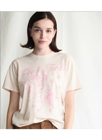 Woman wearing a beige t-shirt with pink text and floral design on a white background
