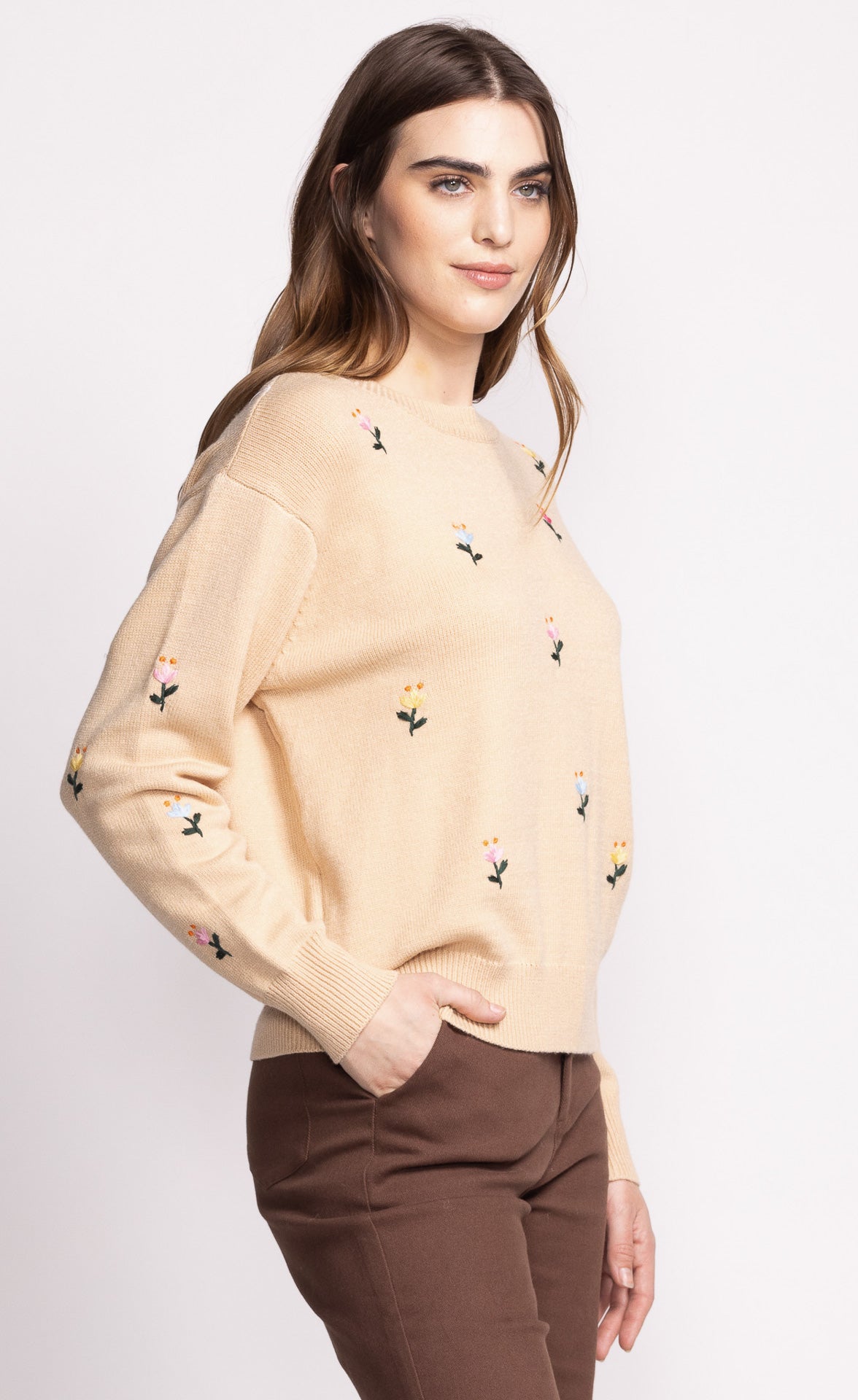 Add a touch of whimsy to your wardrobe with the Pink Martini Eva sweater. This crew neck design features charming embroidered flower details, perfect for adding a playful element to any outfit. Stay cozy and stylish with this unique and fun sweater.