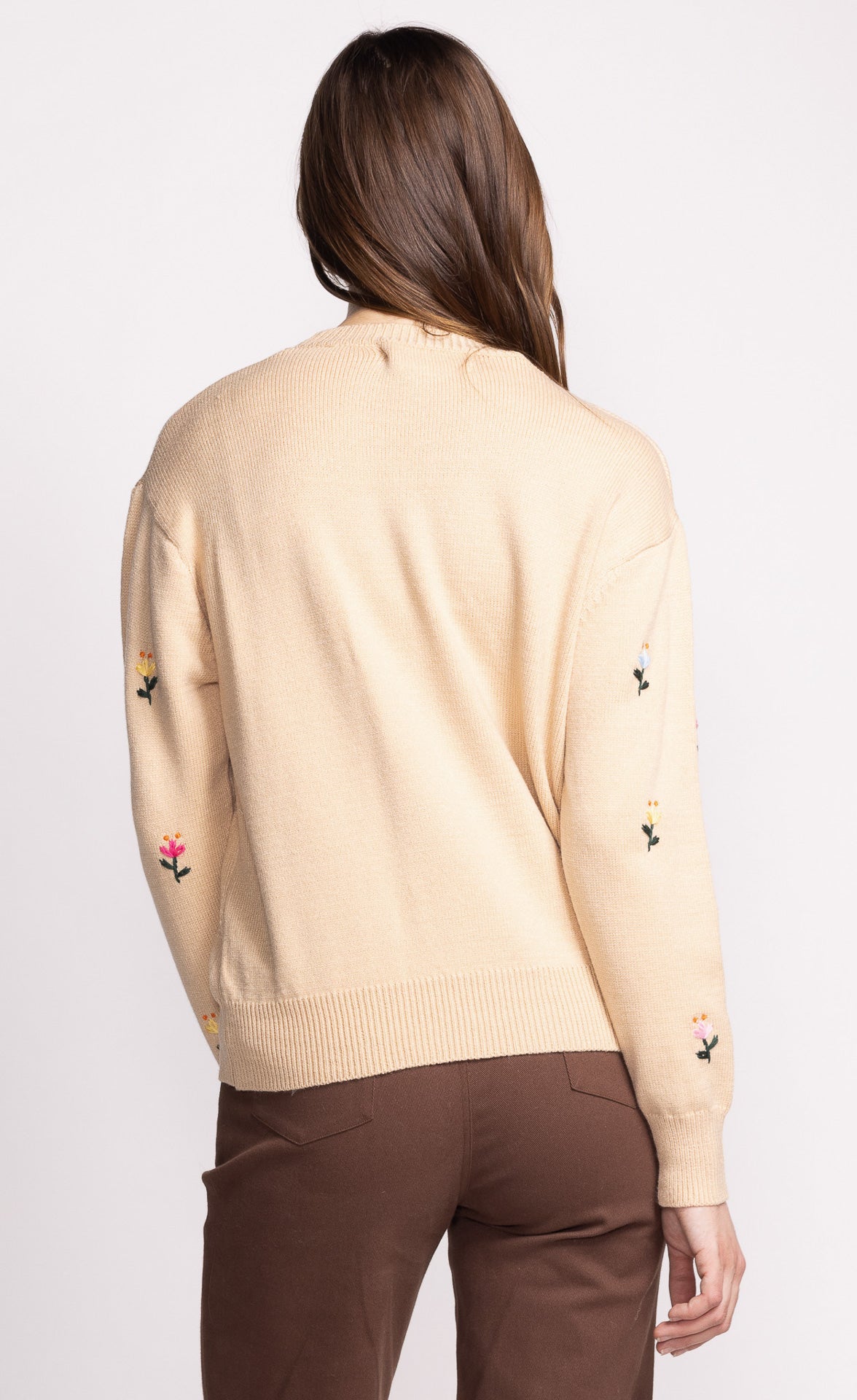 Add a touch of whimsy to your wardrobe with the Pink Martini Eva sweater. This crew neck design features charming embroidered flower details, perfect for adding a playful element to any outfit. Stay cozy and stylish with this unique and fun sweater.