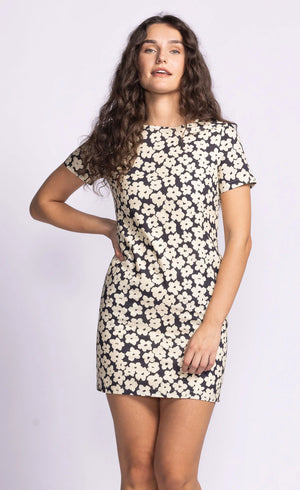 The Charli Dress is a chic shift dress featuring a dainty print, offering a flattering and timeless silhouette. Style it with statement accessories for a polished look or keep it simple with flats for everyday wear.