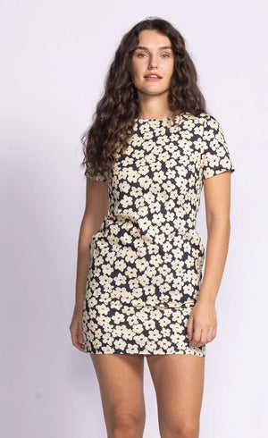The Charli Dress is a chic shift dress featuring a dainty print, offering a flattering and timeless silhouette. Style it with statement accessories for a polished look or keep it simple with flats for everyday wear.