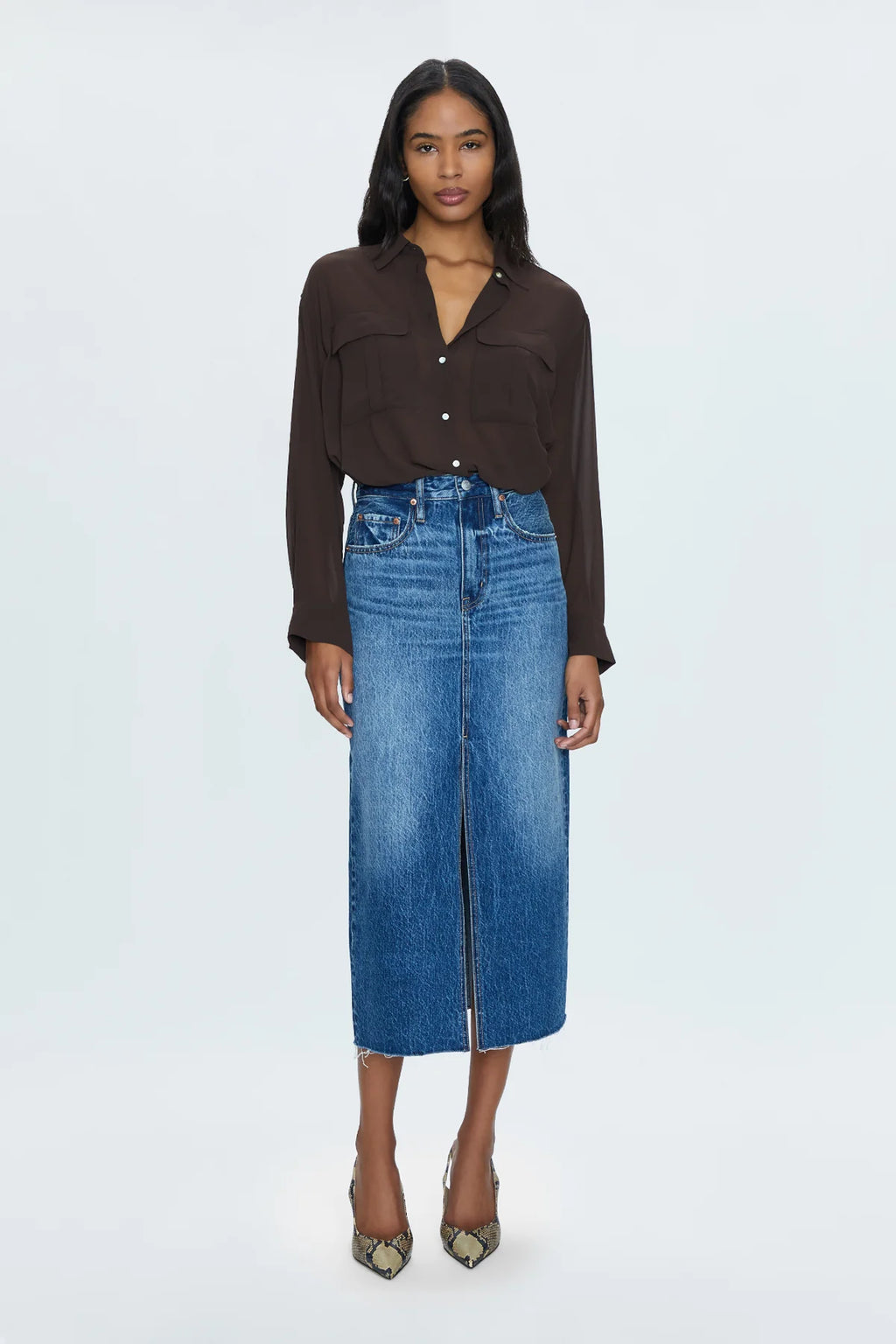 Of-the-moment, yet eternally stylish - our best selling skirt features an elongated midi length and five pocket denim design notes. Crafted from rigid denim without stretch for sophisticated fit and fall, with a well considered front skirt slit for ease of movement. Fairfax is a medium blue denim wash with moderate fading and wiskering, finished with a scissor cut hem.