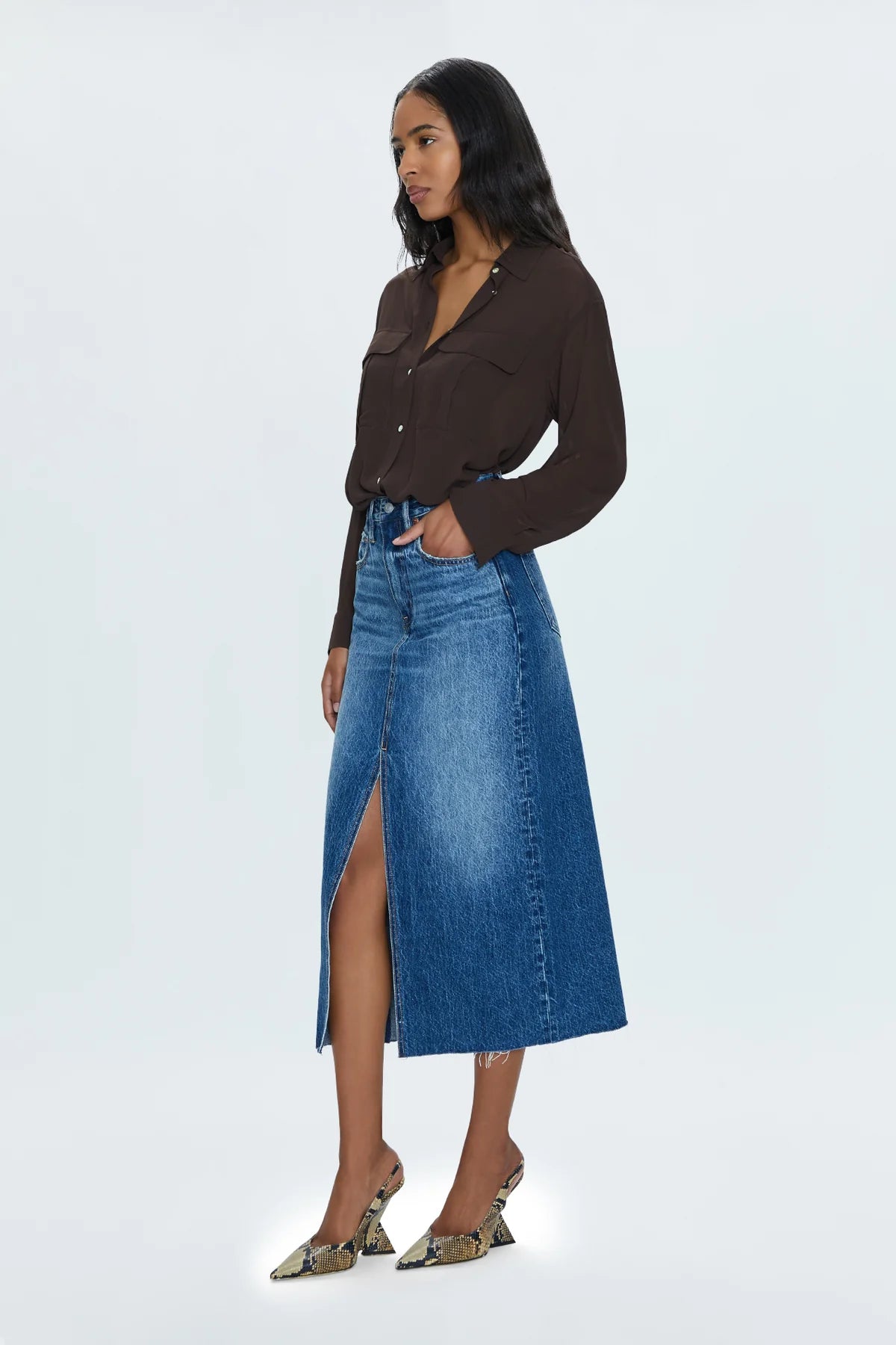 Of-the-moment, yet eternally stylish - our best selling skirt features an elongated midi length and five pocket denim design notes. Crafted from rigid denim without stretch for sophisticated fit and fall, with a well considered front skirt slit for ease of movement. Fairfax is a medium blue denim wash with moderate fading and wiskering, finished with a scissor cut hem.