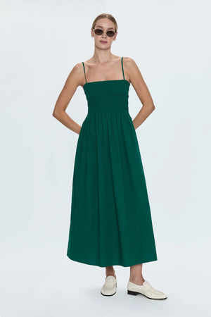 Breezy day dress crafted from a flowing, lightweight fabrication designed for warm weather wear. Smocked bodice with ruched design details, topped with adjustable shoulder straps.&nbsp;