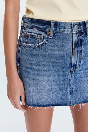 Jaunty mini skirt that sits low on the hips for breezy, cool-girl styling. Crafted from rigid non-stretch denim for an expert fit, and offered in a medium blue denim wash with blasted fading.
