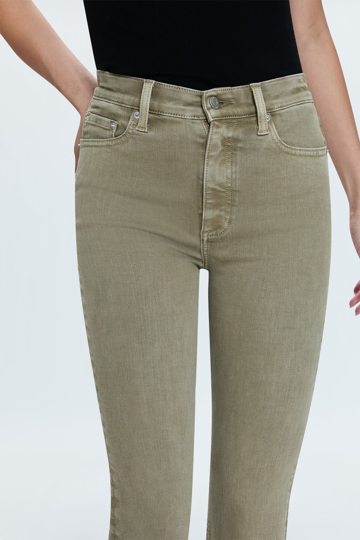 Our best selling bootcut silhouette with a high rise waist and 27" hem length with a clean finish. Crafted from our best selling comfort-stretch denim with clean finishes and free of distressing. Green Willow is a soft, warm olive green colored denim with tonal stitching and chrome hardware.