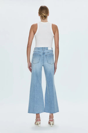 The Izzy mid rise wide leg showcases an slim top block and exaggerated wide leg silhouette with an unexpected kick flare to cropped hem. Cut in a stretch light wash denim.