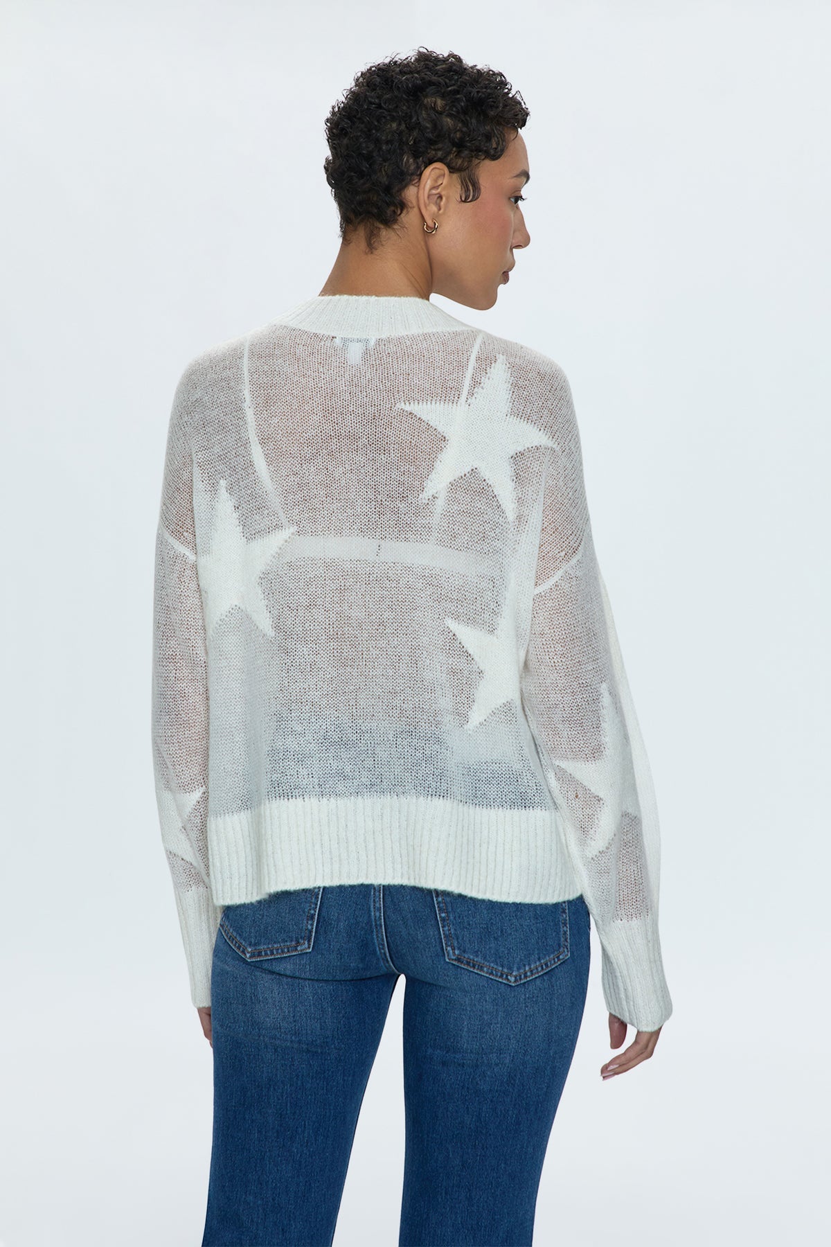 Star power. Ultra lightweight, open knit sheer pullover sweater. With a relaxed, scooped neckline and asymmetrical high low hem. With relaxed single layer ribbing at neckline, cuffs, and hem. Decorated with monochromatic star print motif throughout.&nbsp;