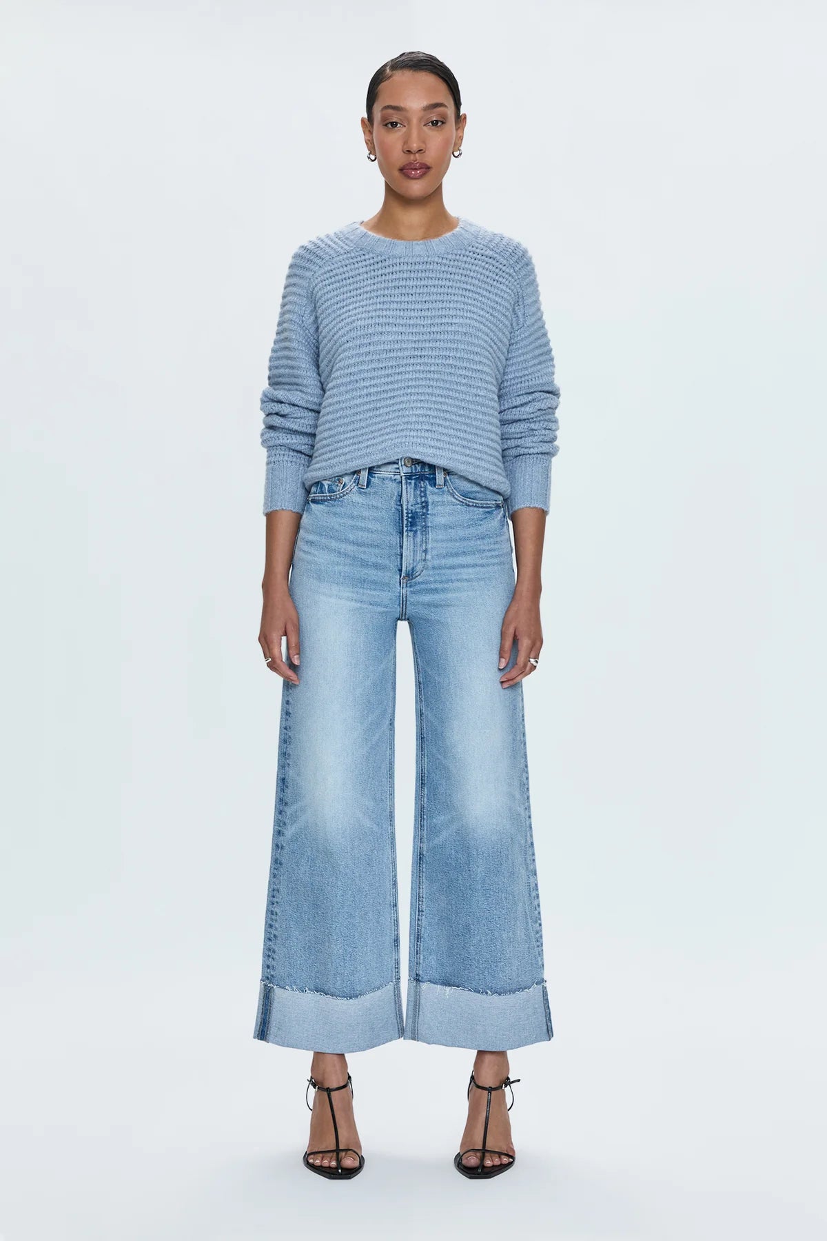 A relaxed, ultra wide leg silhouette with a breezy cropped length cut with a raw finished hem and wide, stitched cuffs. Crafted from our signature comfort stretch denim to provide a structured shape with just the right give. Snowcat is a cool toned light blue denim wash with blasted fading and whiskering and finished with metal hardware.