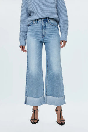 A relaxed, ultra wide leg silhouette with a breezy cropped length cut with a raw finished hem and wide, stitched cuffs. Crafted from our signature comfort stretch denim to provide a structured shape with just the right give. Snowcat is a cool toned light blue denim wash with blasted fading and whiskering and finished with metal hardware.