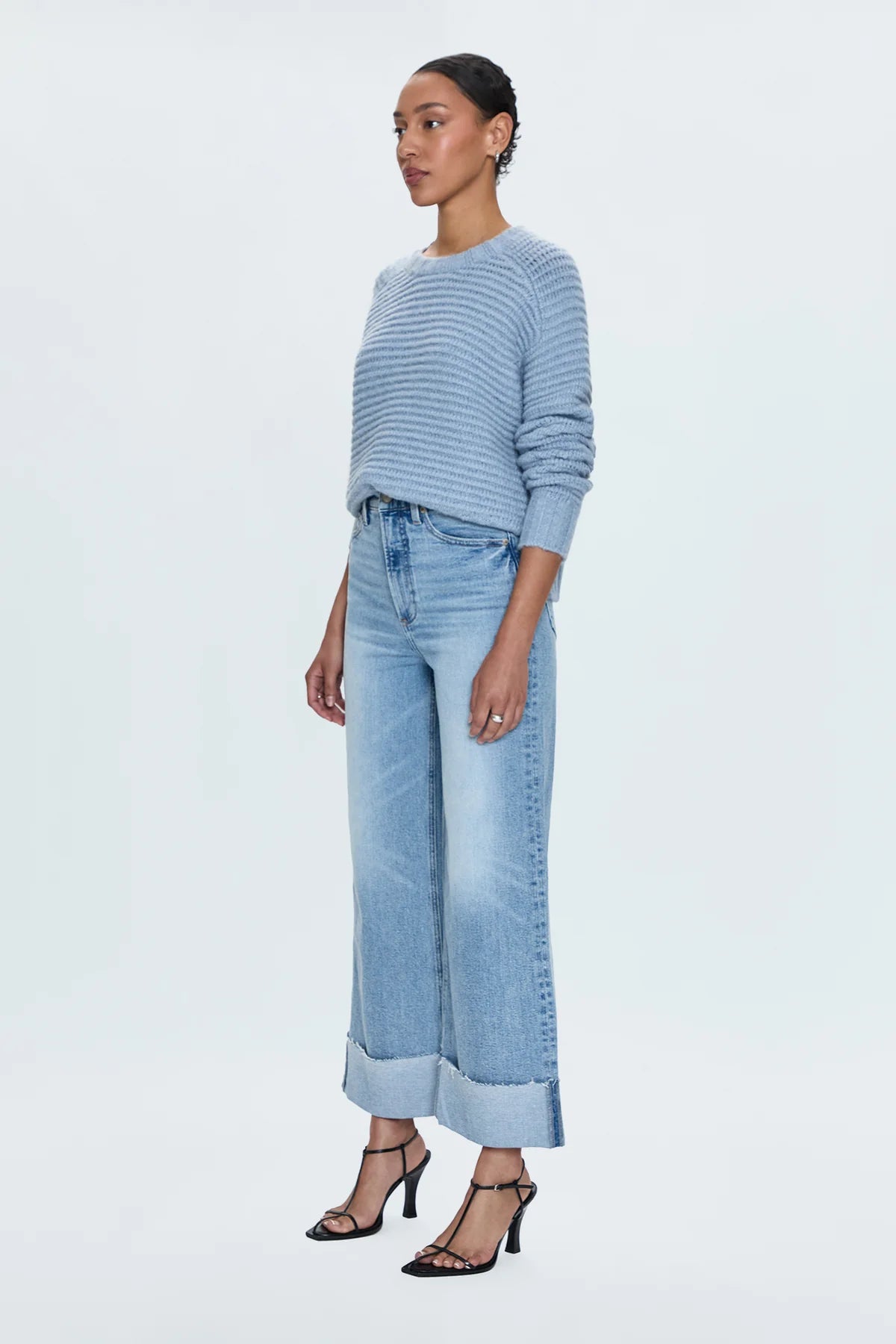 A relaxed, ultra wide leg silhouette with a breezy cropped length cut with a raw finished hem and wide, stitched cuffs. Crafted from our signature comfort stretch denim to provide a structured shape with just the right give. Snowcat is a cool toned light blue denim wash with blasted fading and whiskering and finished with metal hardware.