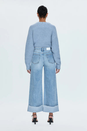 A relaxed, ultra wide leg silhouette with a breezy cropped length cut with a raw finished hem and wide, stitched cuffs. Crafted from our signature comfort stretch denim to provide a structured shape with just the right give. Snowcat is a cool toned light blue denim wash with blasted fading and whiskering and finished with metal hardware.