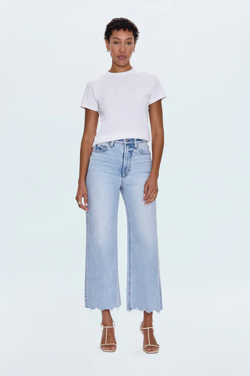 A relaxed, ultra wide leg silhouette featuring a raw finished hem and wide, stitched cuffs. Crafted from our signature comfort stretch denim to provide a structured shape with just the right give. Sun-Kissed Vintage is a light blue, blasted denim wash with a contoured, slimming fade and whisker details.